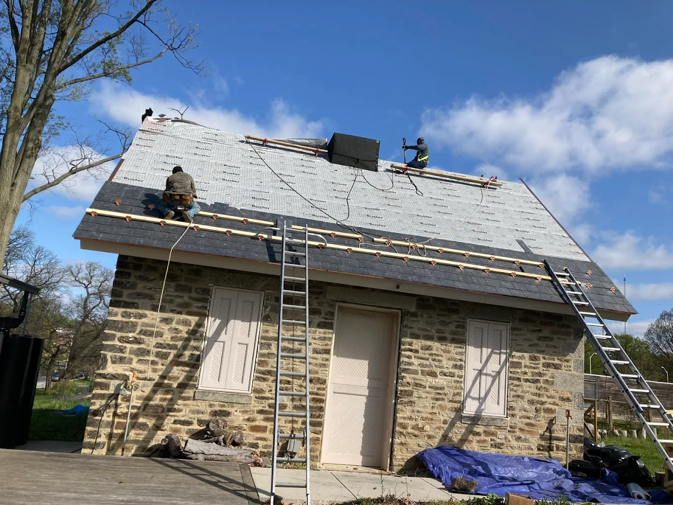 Full slate roof installation on a historic stone home in Baltimore